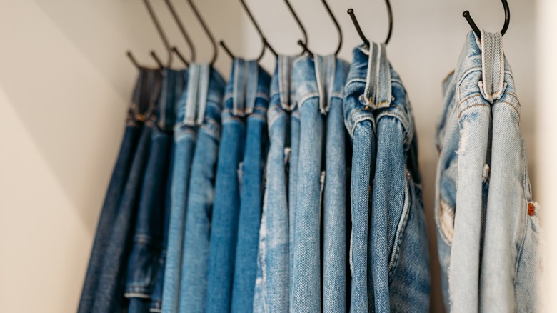 Jeans hanging on hooks