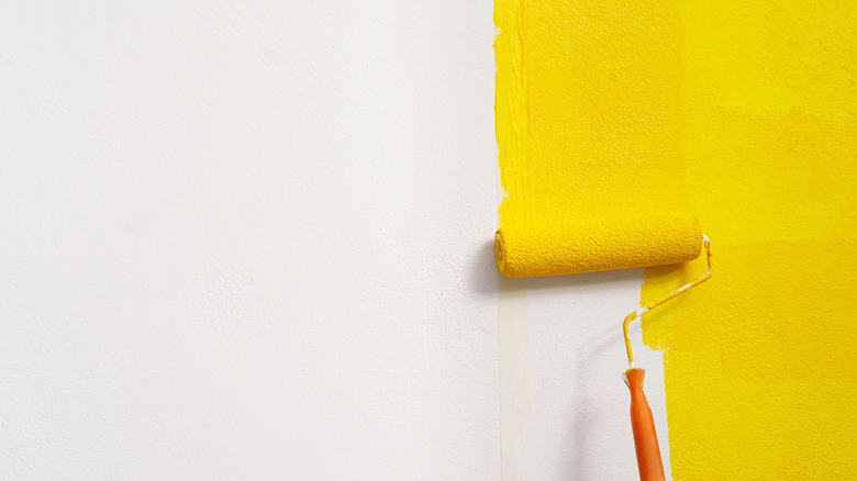 White wall being painted yellow