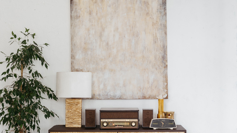 abstract painting hanging above dresser