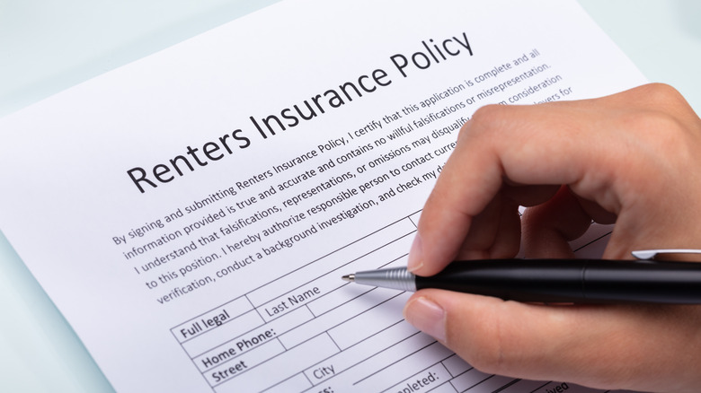 Person signing renters insurance form