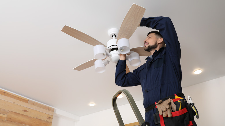 electrician workin on ceiling fan