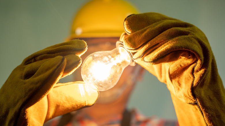 electrician holding light bulb