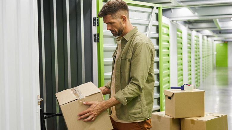 man putting away boxes