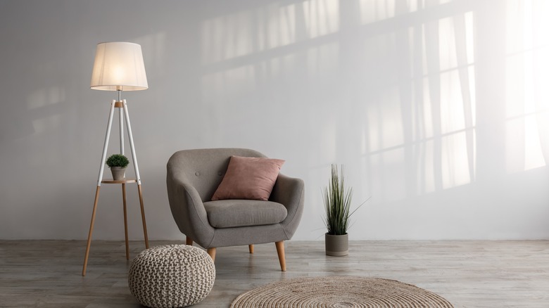 Room with lamp and shadows on white wall