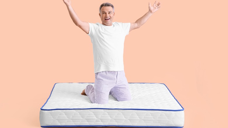 Man kneeling on mattress