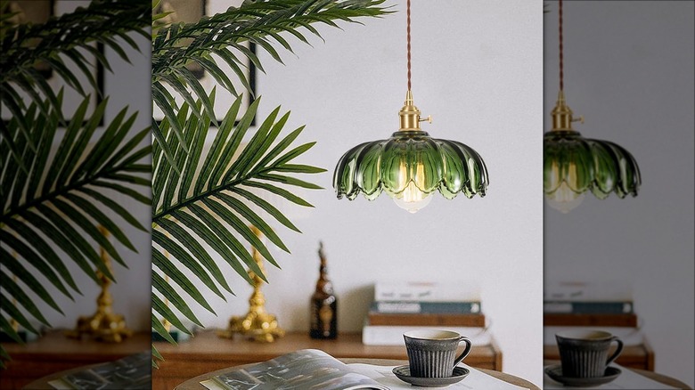 Vintage green pendant light over table with mug