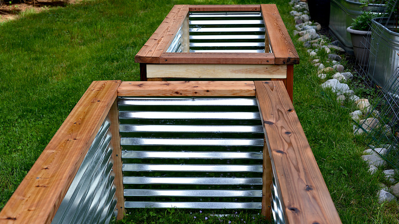 Empty wood and metal planter boxes in garden