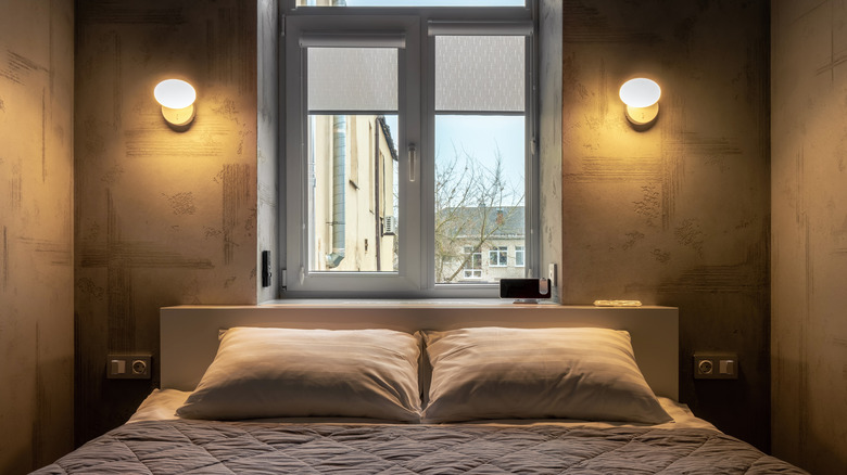 Bedroom with sconces above the bed