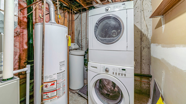 stacked washer and dryer in an unfinished basement