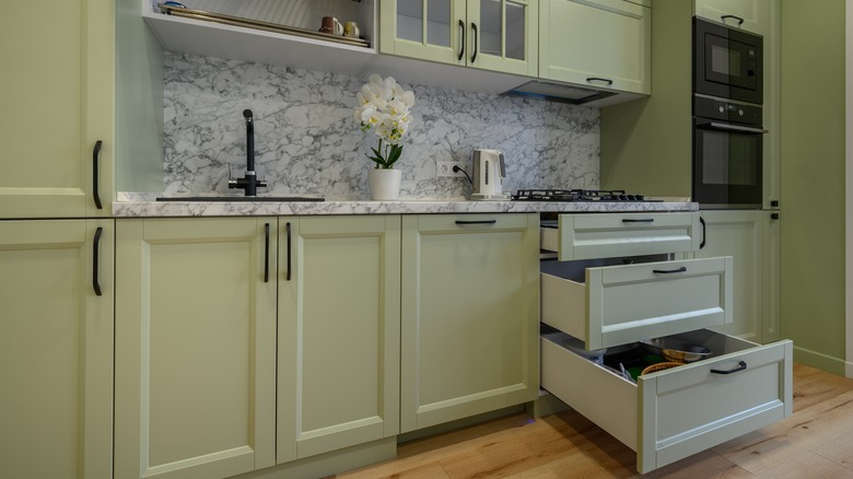 Muted green kitchen cabinets 