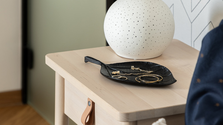 Dish with jewelry on nightstand