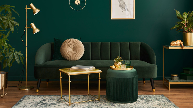 Green-colored room with vintage sofa