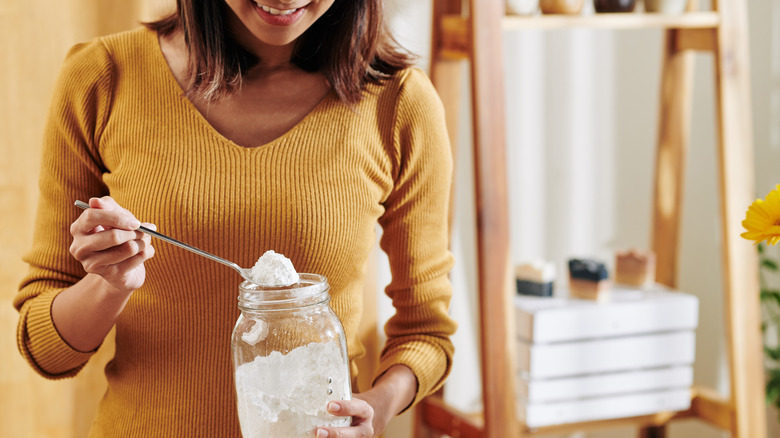 woman scooping baking soda