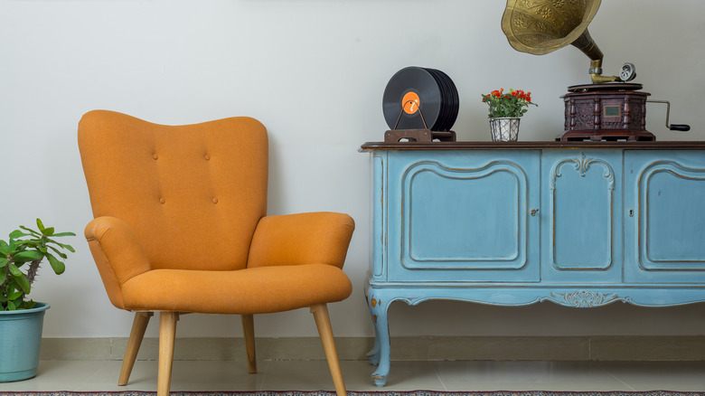 orange chair with blue cabinet