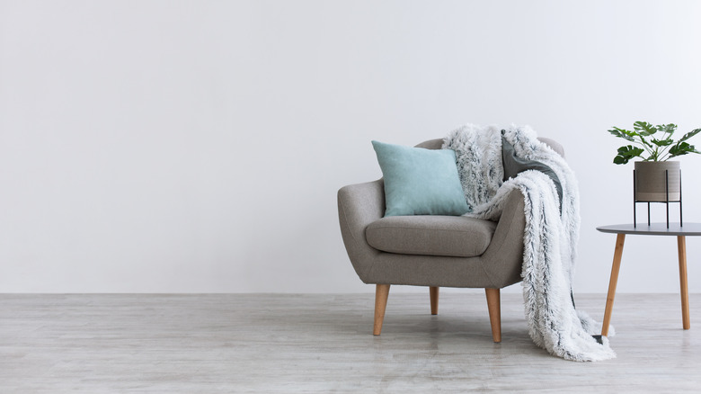 gray chair with blue pillow