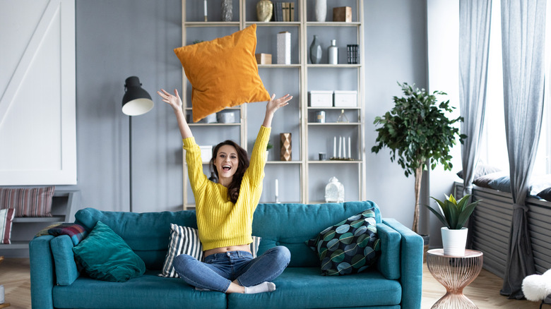 woman tossing a pillow