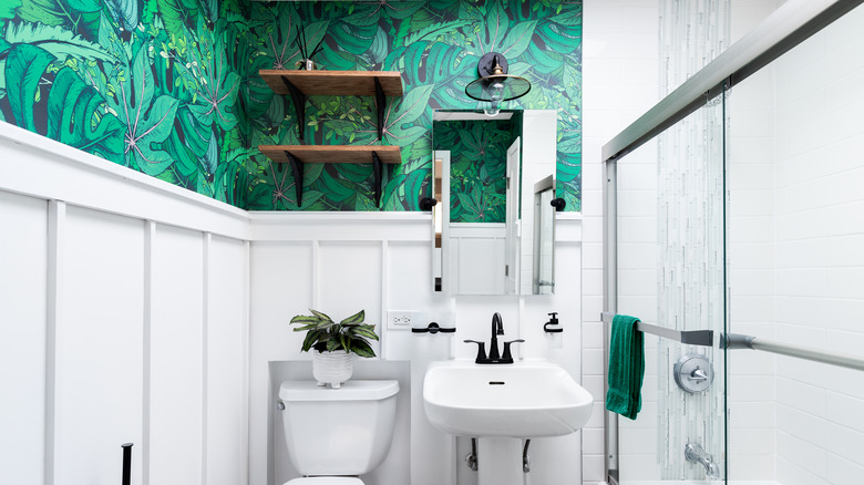 white bathroom with leaf wallpaper