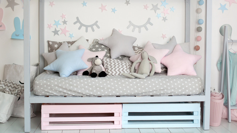 child's bed with pastel drawers