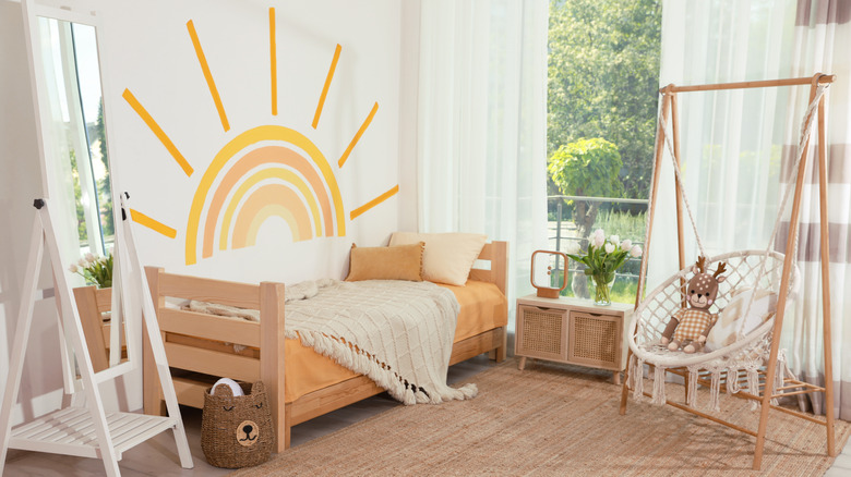 sun mural above wooden bed