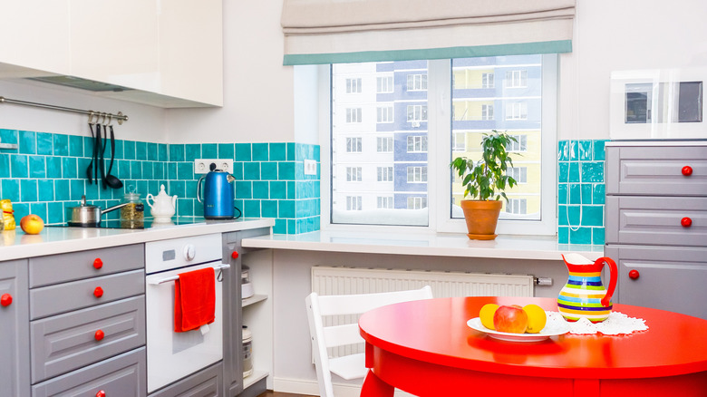 Kitchen with teal backsplash