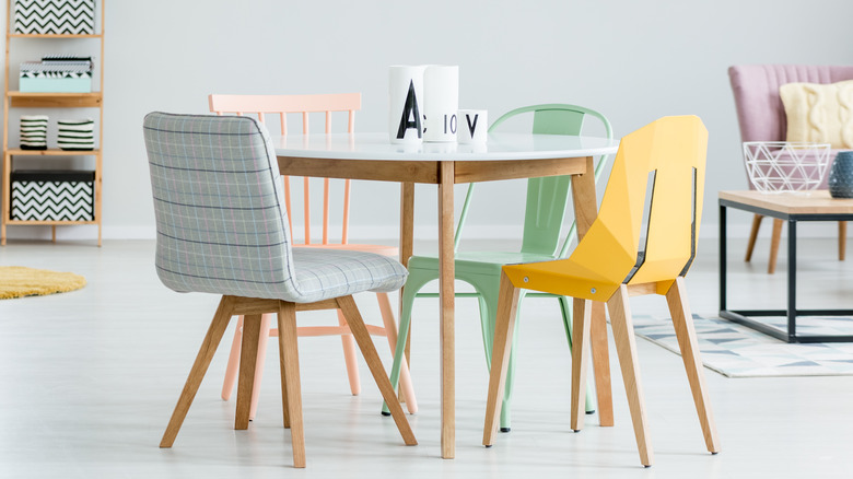 different colored chairs around table