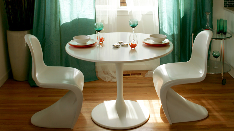 table with unique white chairs