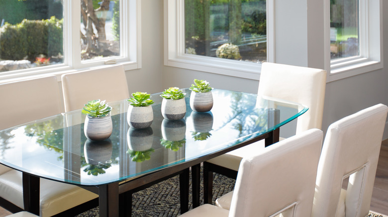 glass table and white chairs