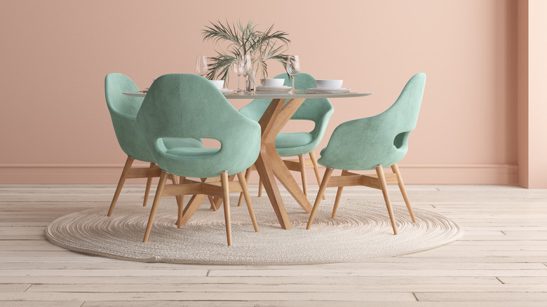 pink wall and teal chairs