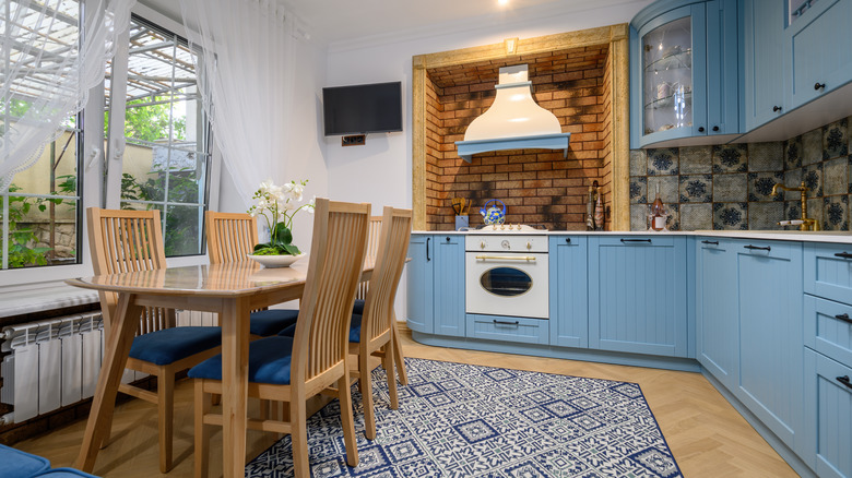 wooden table in blue kitchen