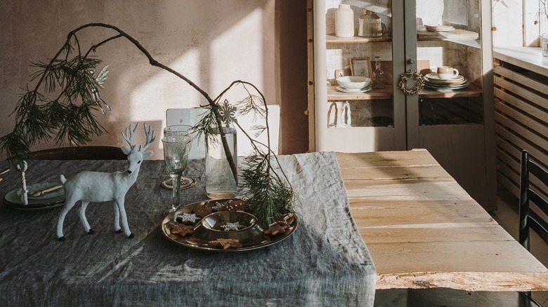 gray tablecloth with rustic branch