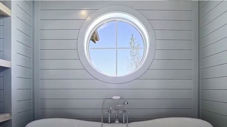 Porthole window above bathtub