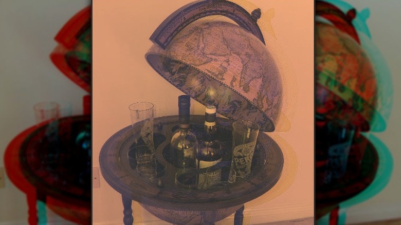 Globe bar with rum and glasses