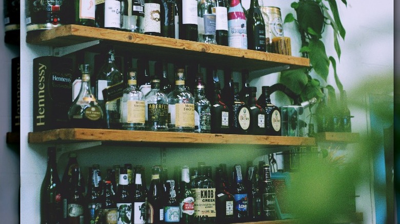 Spirit shelves anchored to a white dry wall