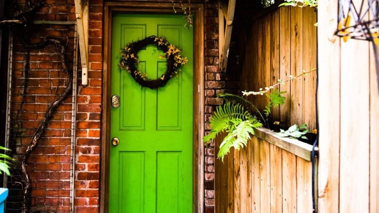 Green door on carriage house