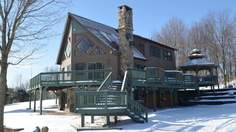 snowy home with deck