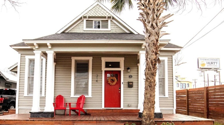 Pretty home behind palm tree