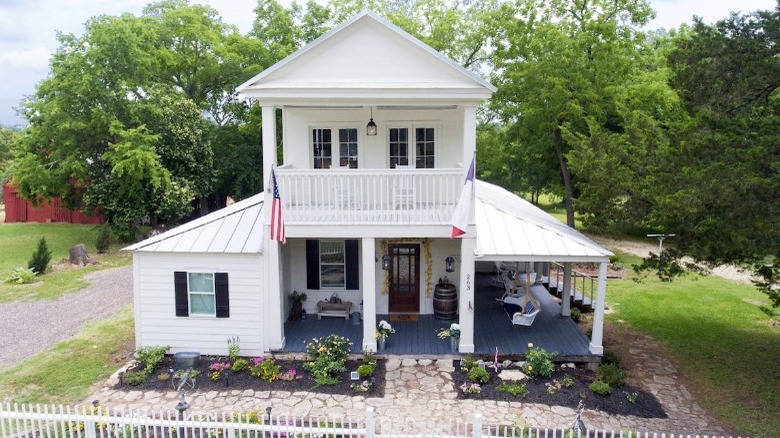 white house with flowerbeds