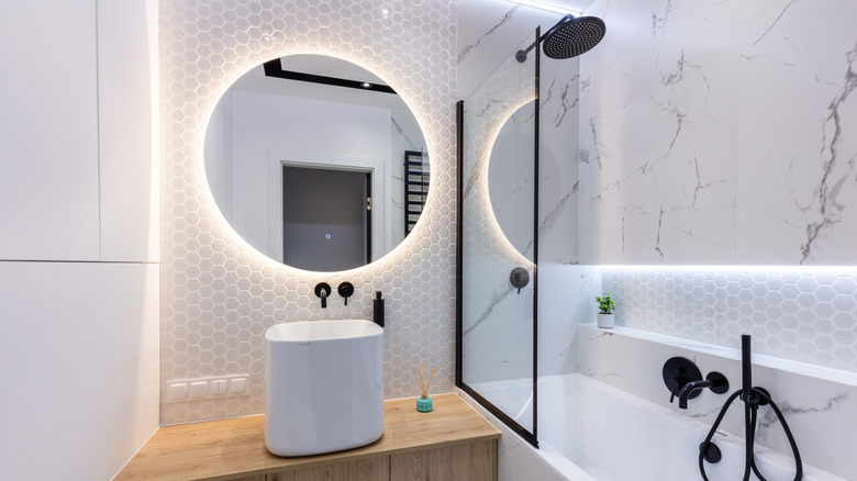 Small bathroom with backlit mirror