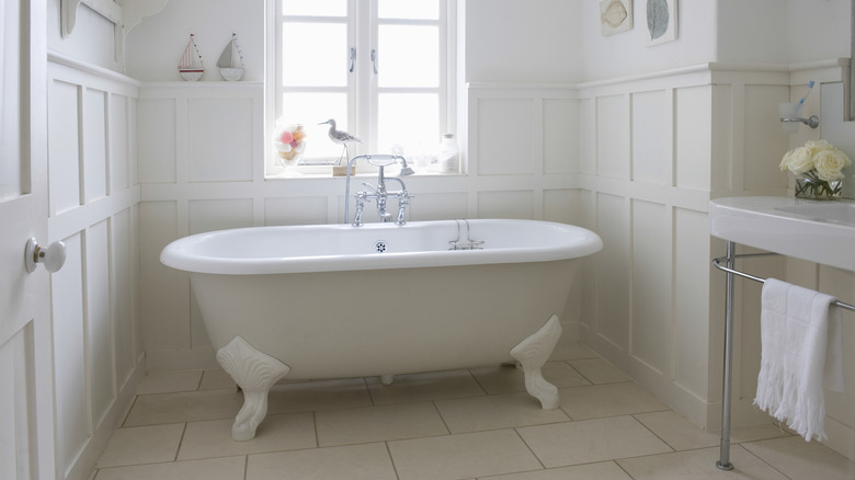 White bathroom with claw foot bathtub