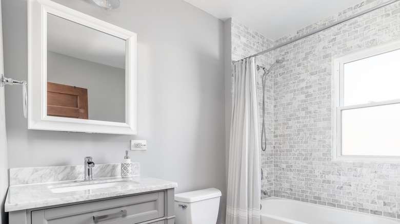 Gray bathroom with medicine cabinet