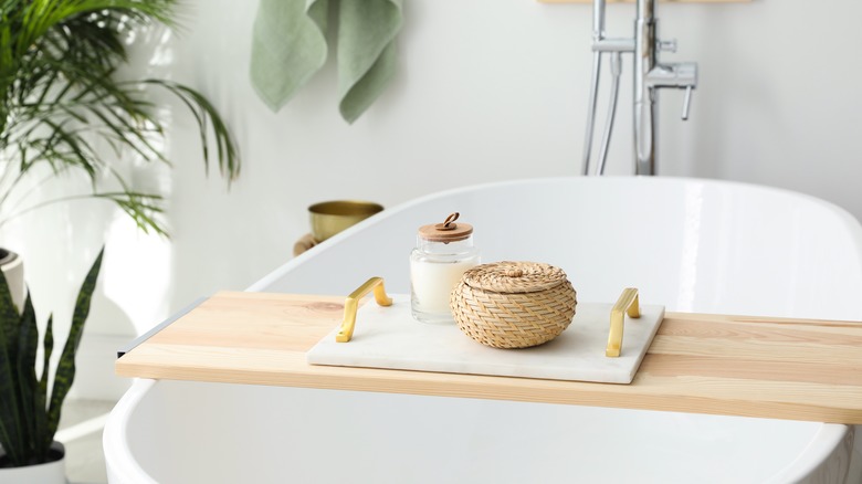 Bamboo tray on white bath tub