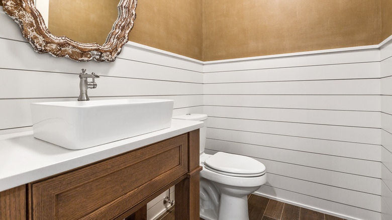 White and tan bathroom with shiplap