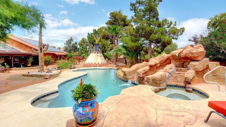 pool next to house and teepee