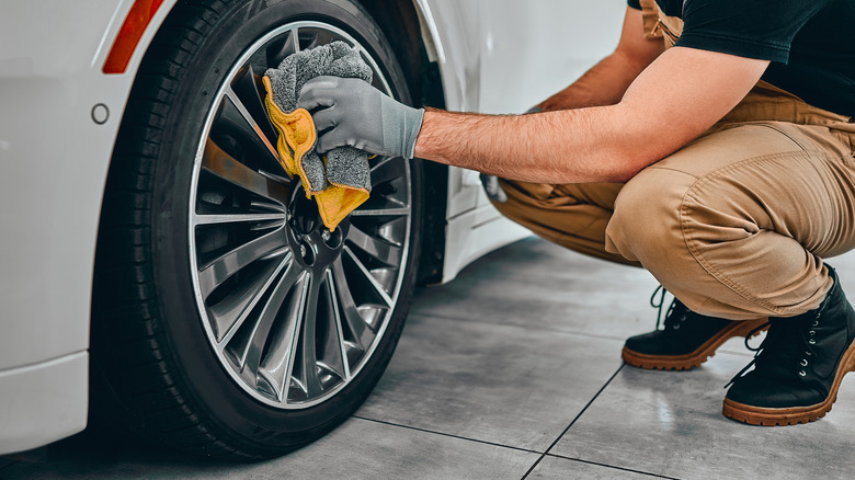 Man cleaning wheel disc