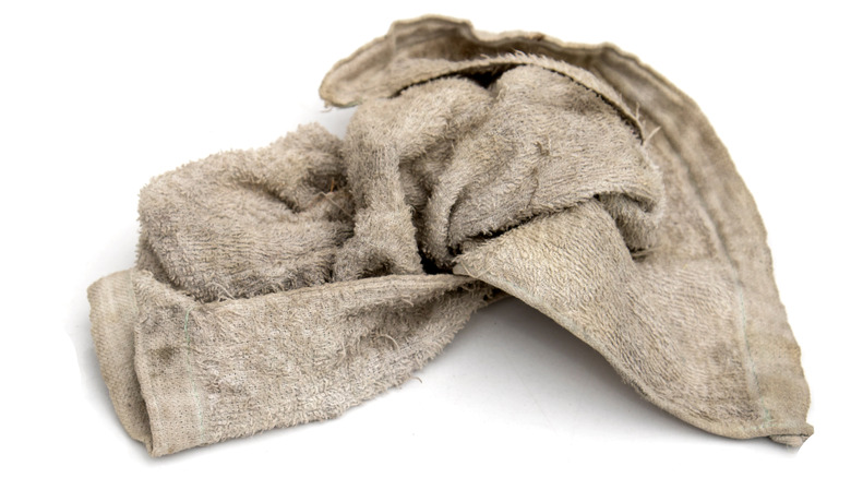 Old dirty towel on white background