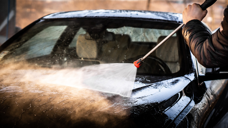 Hand pressure-washing car