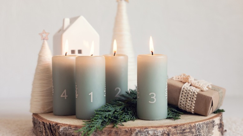 Four Advent candles on wood