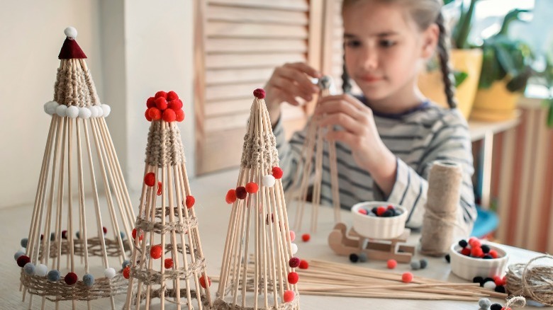 Child making DIY Christmas trees