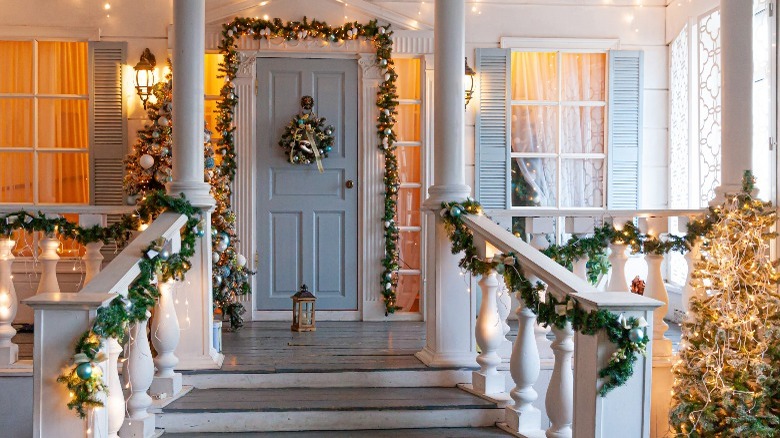 Front porch decorated with garland