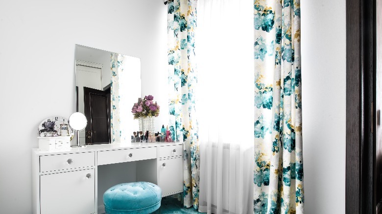 Vanity next to floral curtains